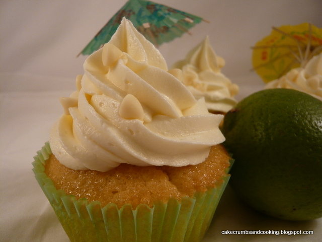 A mojito cupcakes with a swirly top and paper umbrella.