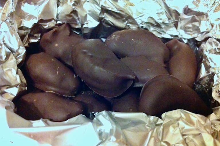 Homemade chocolate brazils nestled in silver paper.