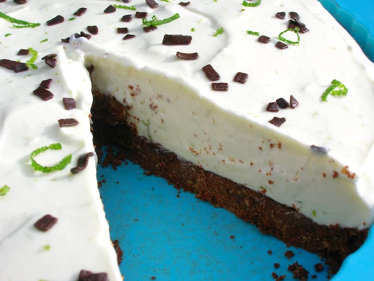 Chocolate key lime pie with a slice removed.