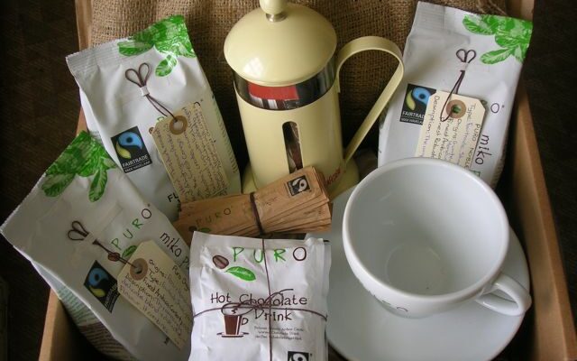 A box of Puro products including coffee, hot chocolate, a cafetiere and cup.