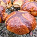 Homemade hot cross buns with a chocolate cross.