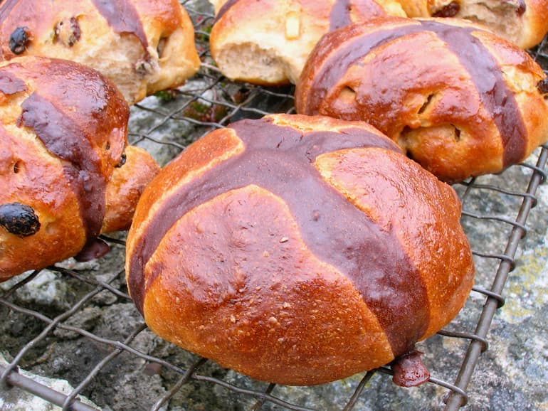 Homemade hot cross buns with a chocolate cross.
