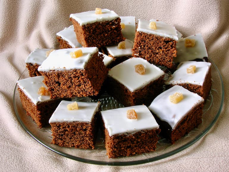 A stack of iced honey spice cakes on a plate.