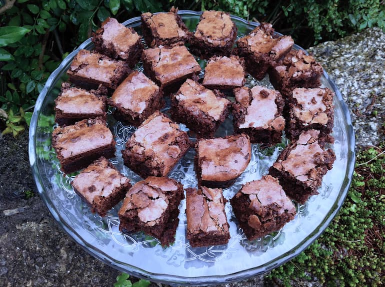 A glass platter of sour cherry brownies.