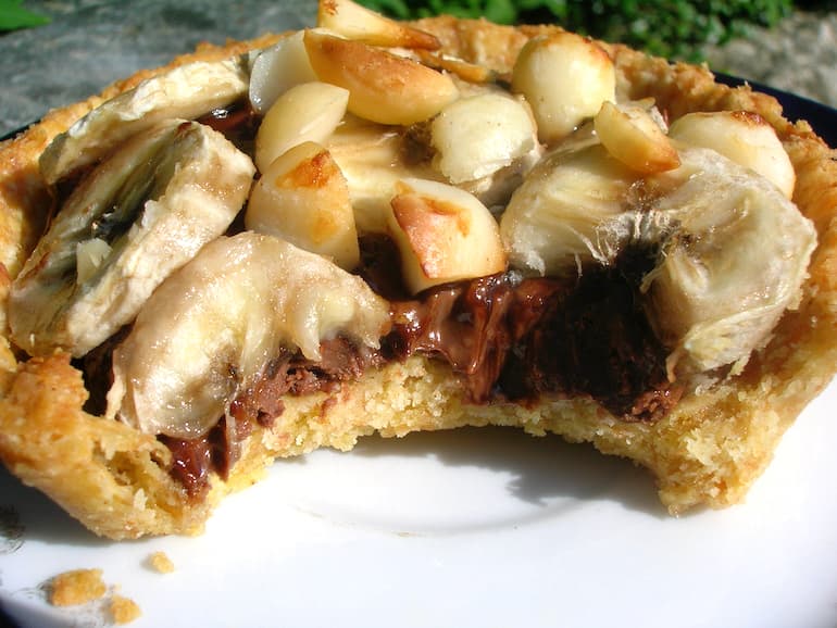 A Nutella and banana tart with a big bite taken out of it.