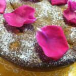 Rhubarb Polenta Cake topped with rose petals.