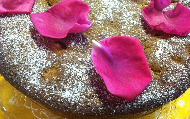 Rhubarb Polenta Cake topped with rose petals.