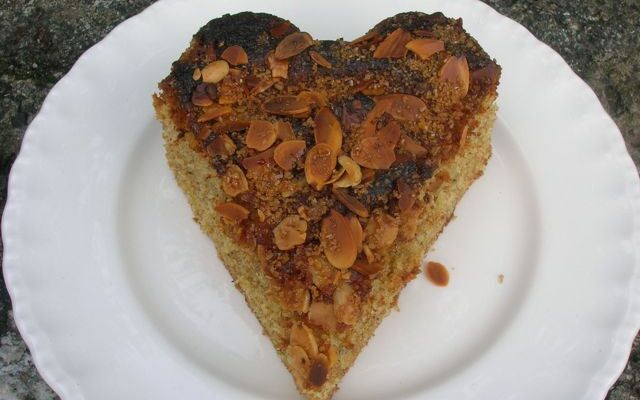 A heart shaped sliced of lemon almond cake.