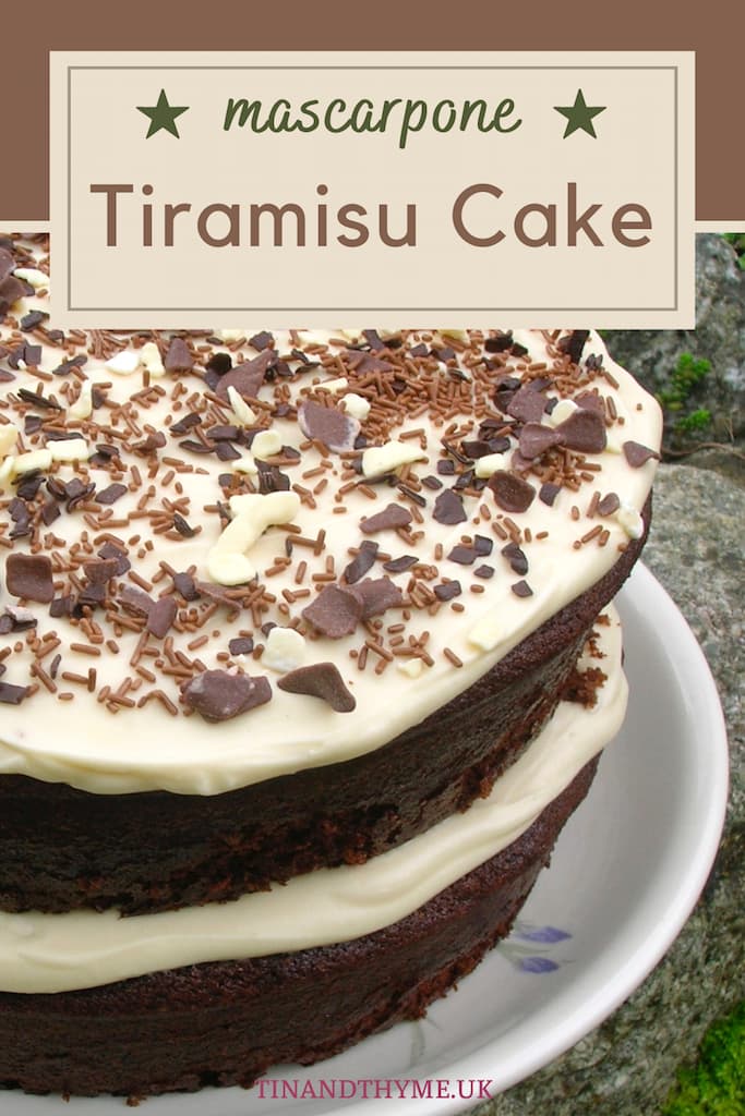 A partial view of a two layer tiramisu cake with chocolate sprinkles. Text box reads "mascarpone tiramisu cake".