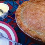 Rhubarb pasty pie ready to be served with clotted cream.