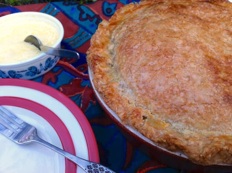 Rhubarb pasty pie ready to be served with clotted cream.