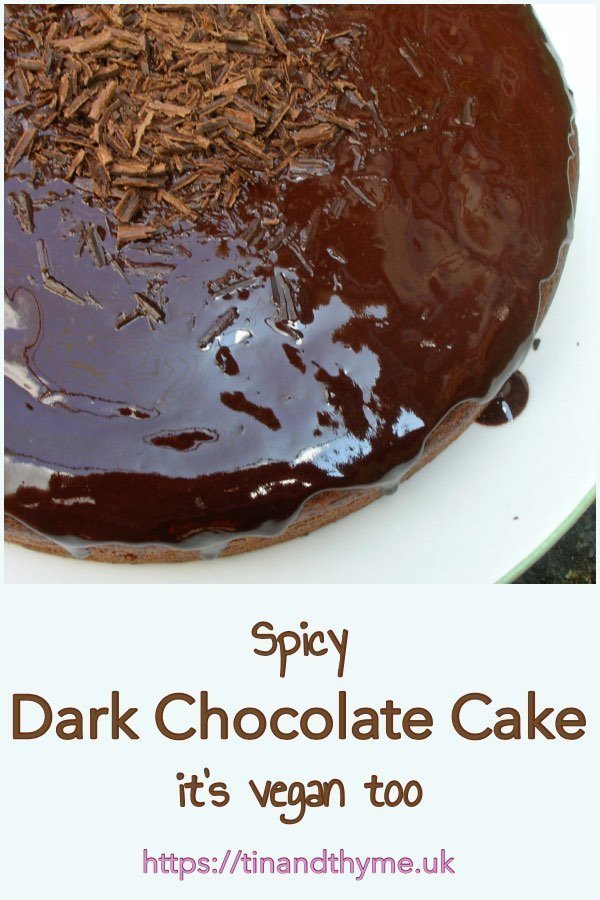 Partial view of a glazed vegan spicy dark chocolate cake.