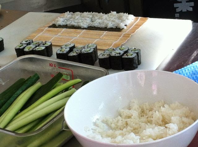 Top tips for rolling sushi. A rolling mat with sushi ingredients.