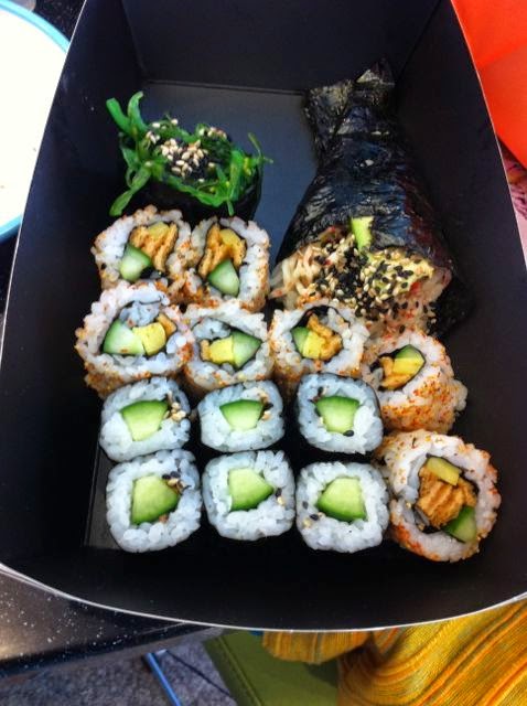A selection of sushi in a takeaway bento box.
