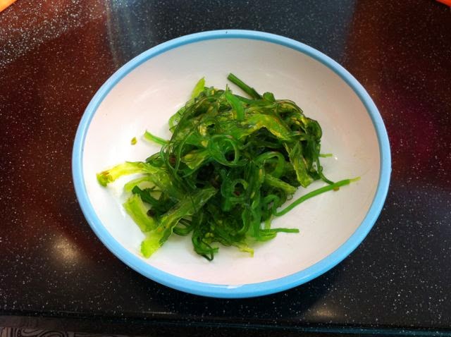 A bowl of green sushi seaweed.