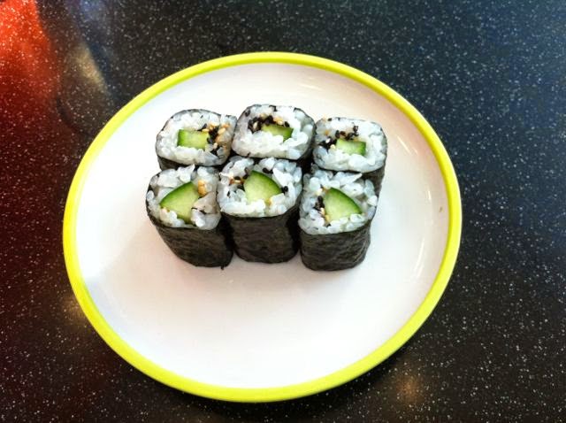 Six vegan sushi rolls on a plate.