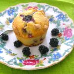 Blackberry and white chocolate lava cake on plate with fork.