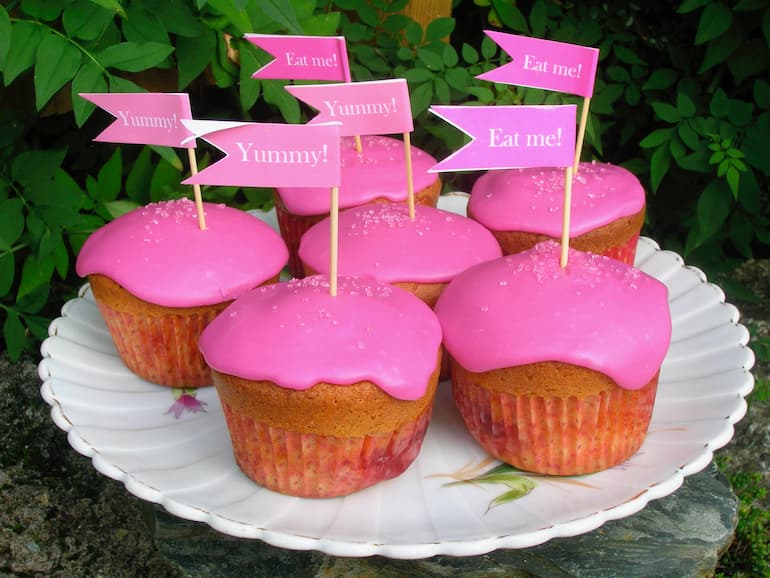 Shocking pink beetroot and orange cupcakes with flags.
