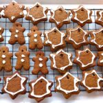 A wire rack filled with iced gingerbread.