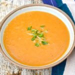 Bowl of roasted tomato soup with lentils and carrots.