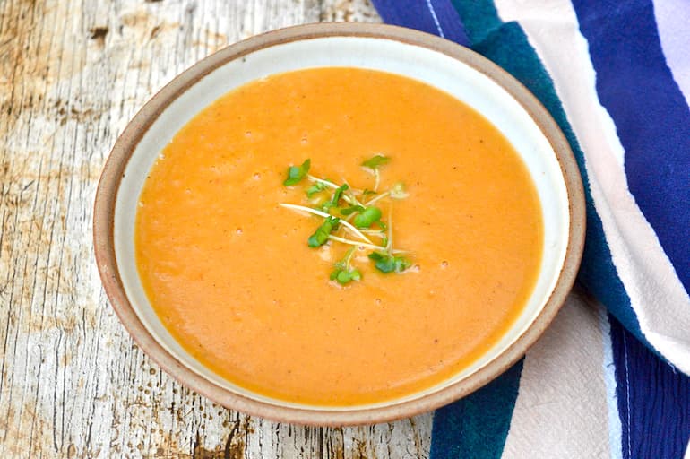 Bowl of roasted tomato soup with lentils and carrots.