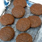 Homemade chocolate brownie cookies on wire rack.