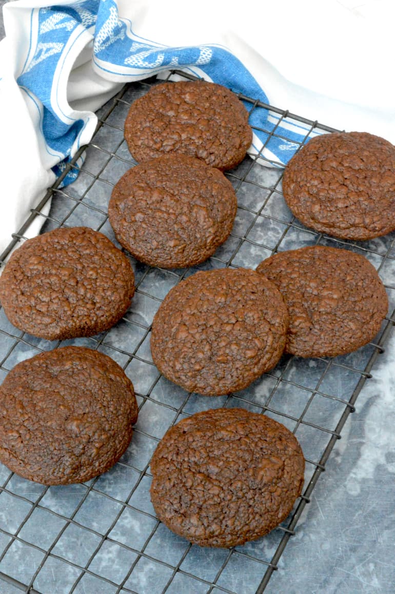 Homemade chocolate brownie cookies on wire rack.