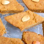Diamond shaped basbousa slices with almond on top.