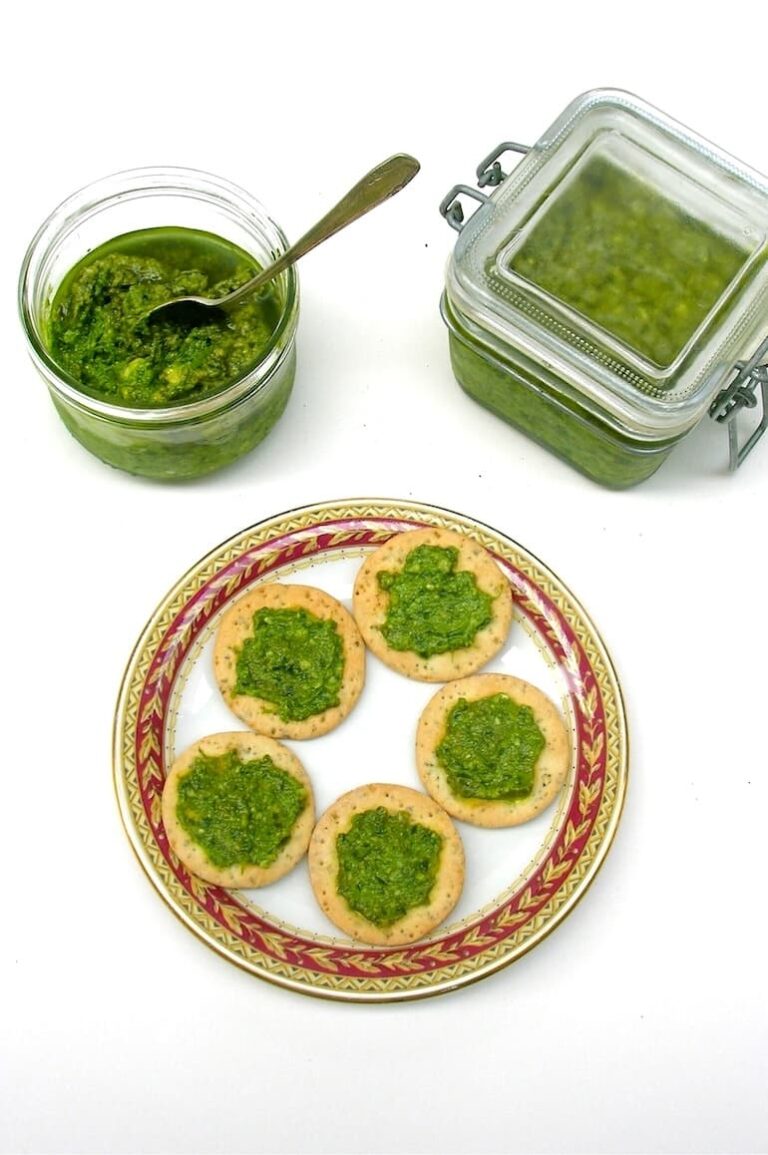 Two jars of garden pesto made with fat hen and chickweed with some spread on crackers.
