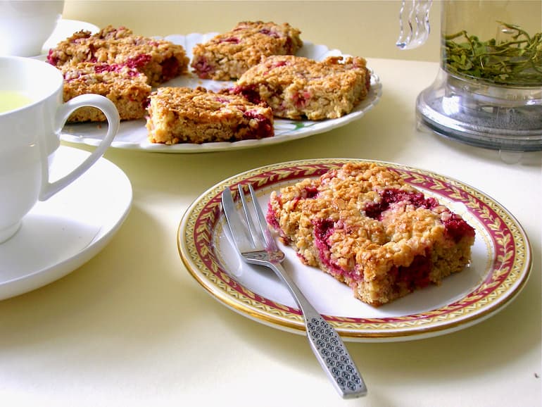 Raspberry and white chocolate flapjacks laid out for afternoon tea.
