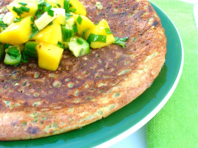 Courgette chickpea pancake with mango and cucumber salsa on top.