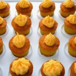 Homemade orange cakes on mini cupcake tray.