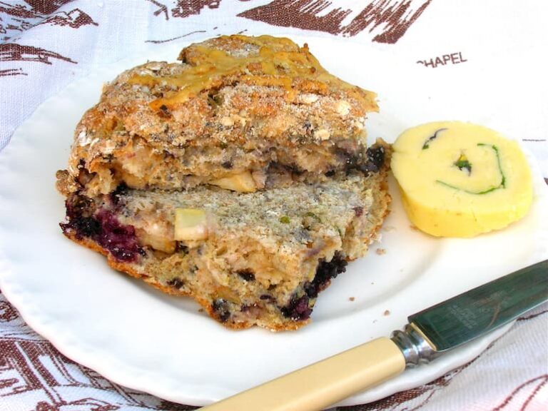 A chunk of blackberry and apple soda bread with a slice of nasturtium butter.