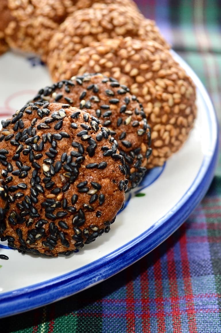 Partial view of both black and white sesame halva biscuits on a plate.