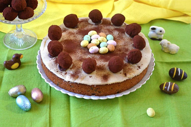 Chocolate simnel cake with chocolate truffles and Easter decorations.