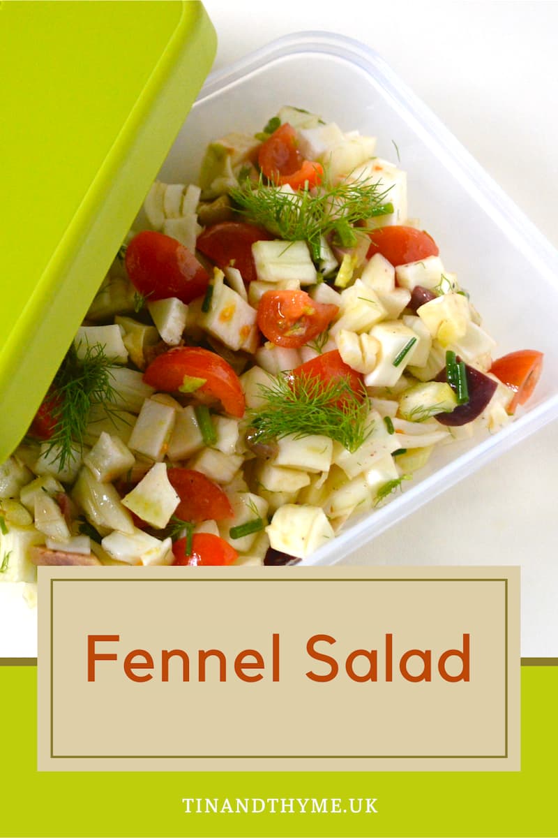 A food container of fennel salad with green lid on the side.