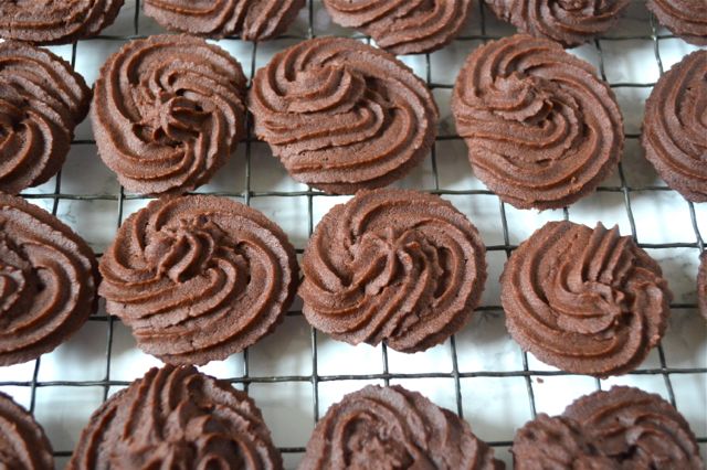 Chocolate Viennese Whirls cooling on a wire rack.