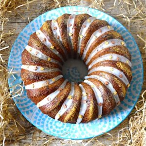 A fig, almond and marzipan bundt cake swirled with icing and dusted in glitter and stars.