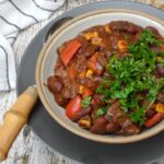 Veggie bean chilli in bowl with spoon.