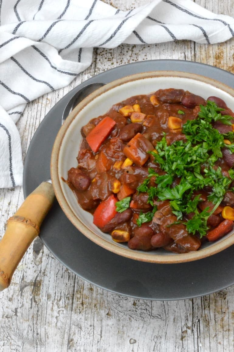 Veggie bean chilli in bowl with spoon.