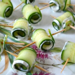 A plate of cucumber roll-ups with a garlic feta mint filling.