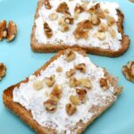 Goat curd cheese, raw honey and walnuts on two slices of toast.