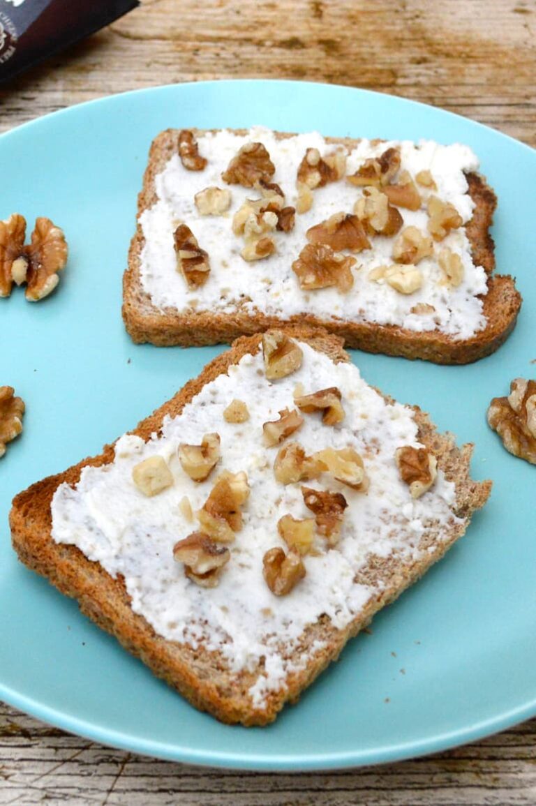 Goat curd cheese, raw honey and walnuts on two slices of toast.