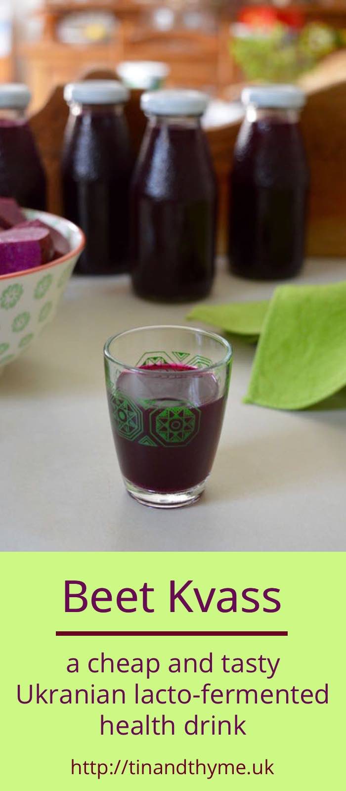 A glass of homemade beet kvass with several bottles of it in the background.