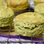 Spelt scones with kefir, matcha and honey on rack.