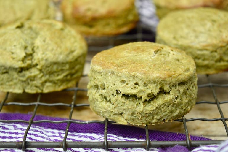 Spelt scones with kefir, matcha and honey on rack.