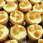 Close up of homemade apple crumble and custard mini cakes.