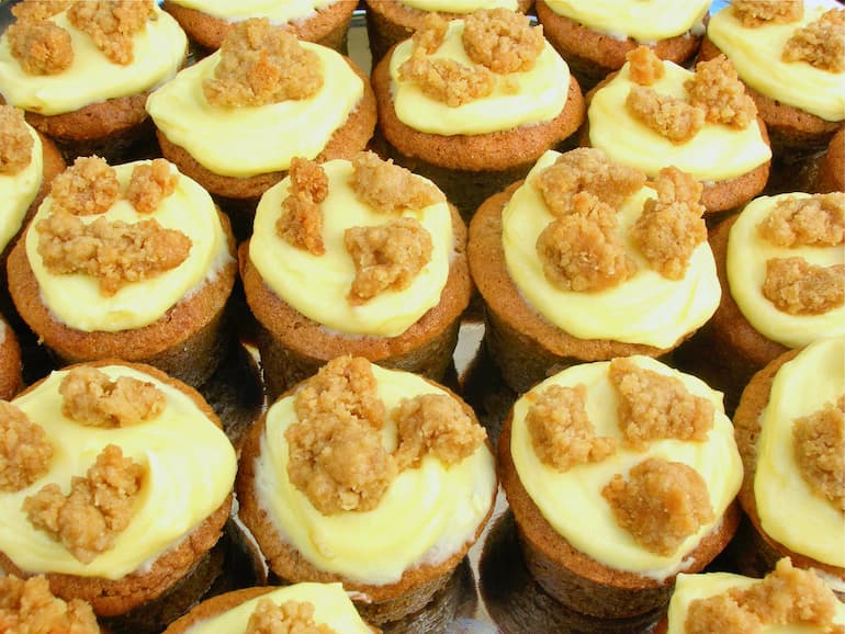 Close up of homemade apple crumble and custard mini cakes.