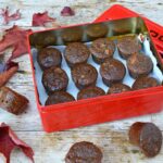 Sticky ginger apple cakes in tin with some on table amongst autumn leaves.