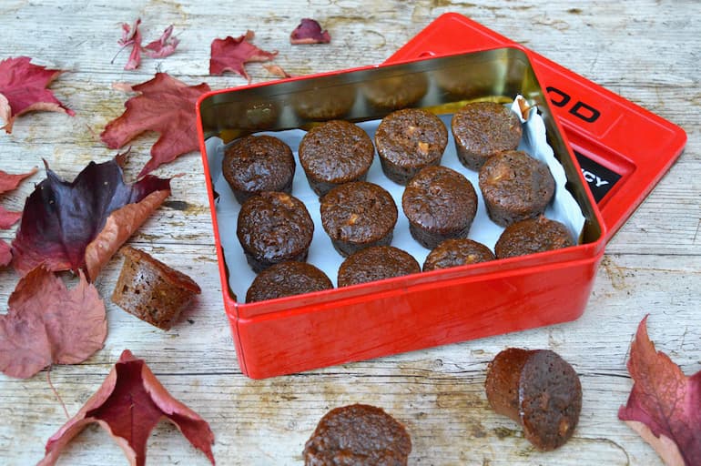 Sticky ginger apple cakes in tin with some on table amongst autumn leaves.